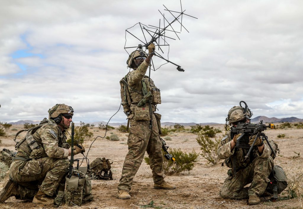 U.S. Army Soldiers assigned to 1st Stryker Brigade Combat Team, 2nd Infantry Division use satellite communication systems